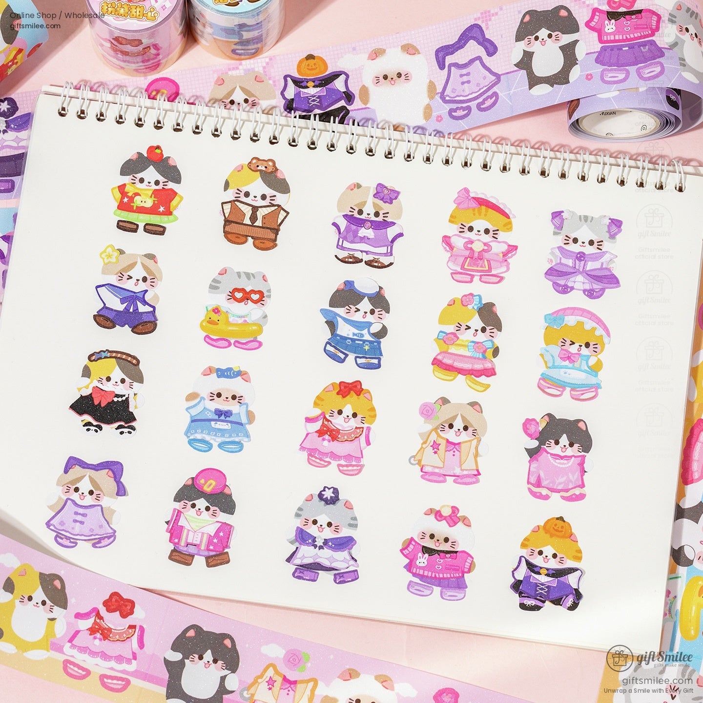 Sheet of cat-shaped stickers in various outfits displayed on a planner