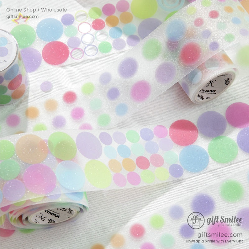 Close-up view of glittery pastel circle-patterned washi tape rolls