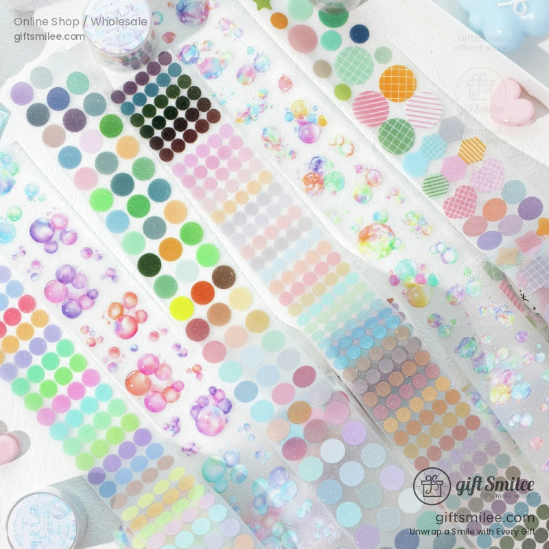 Full set of holographic pastel washi tape rolls with bubble and dot patterns, laid out for crafting inspiration