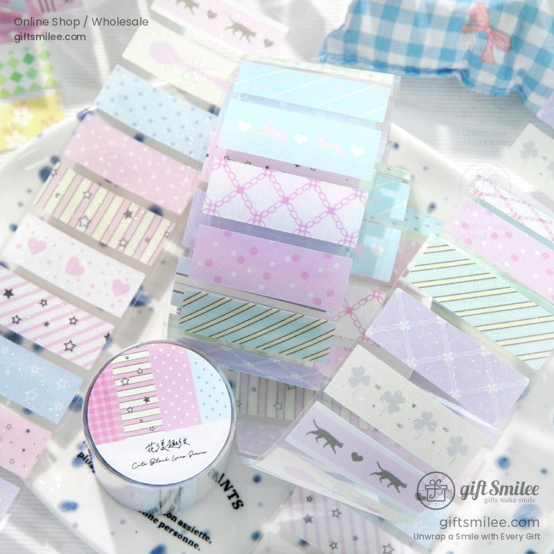 A set of pastel washi tapes unrolled, highlighting elegant stripes, hearts, and starry designs