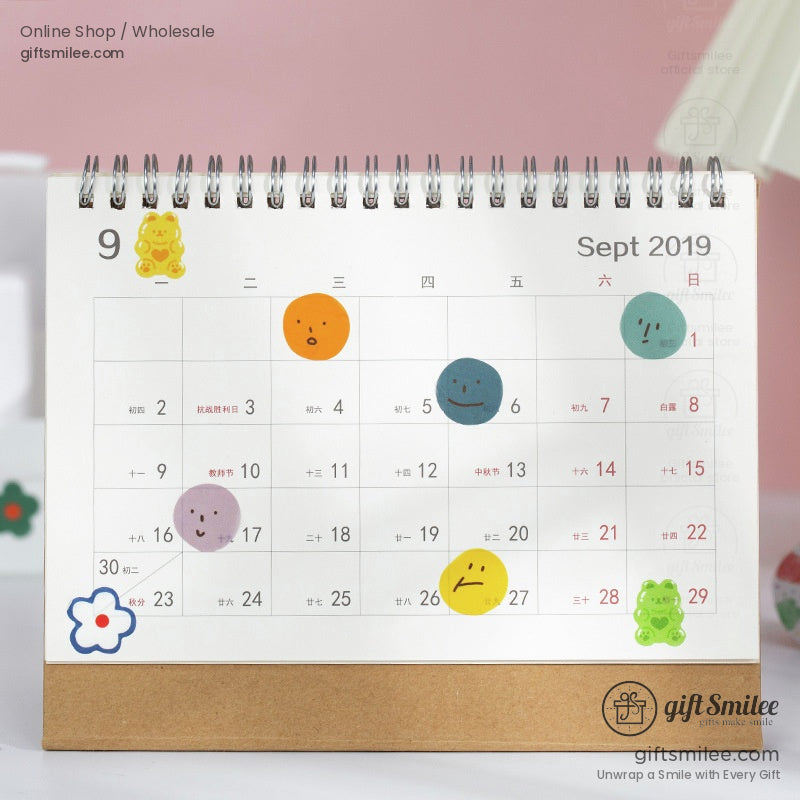 A calendar decorated with colorful smiley face stickers and bear-themed washi tape