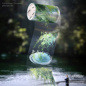 Transparent washi tape roll with a serene nature scene of rippling water and lush greenery