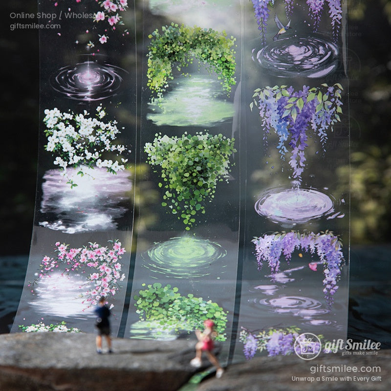 Transparent washi tape roll with a serene nature scene of rippling water and lush greenery