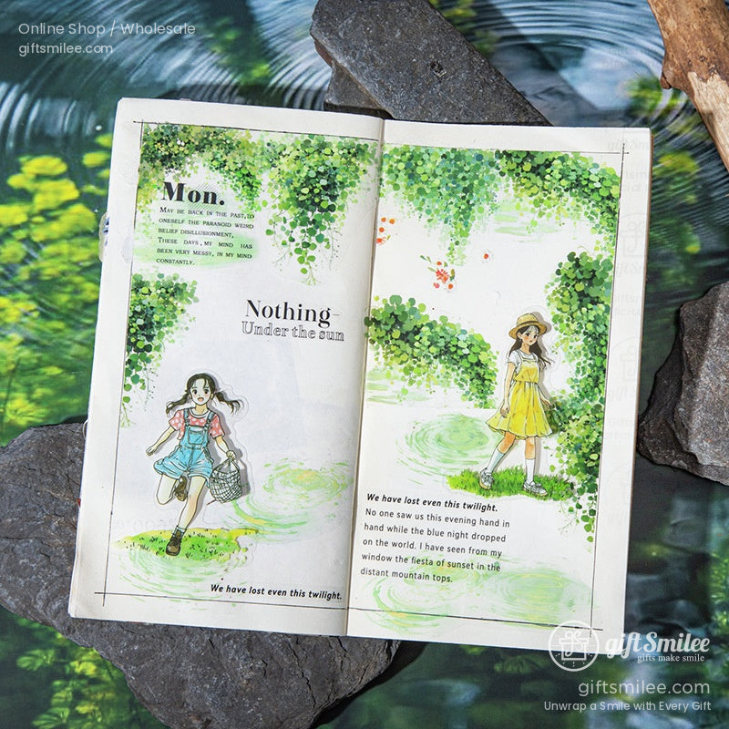 Open journal decorated with transparent washi tape showcasing vibrant greenery and water-inspired designs