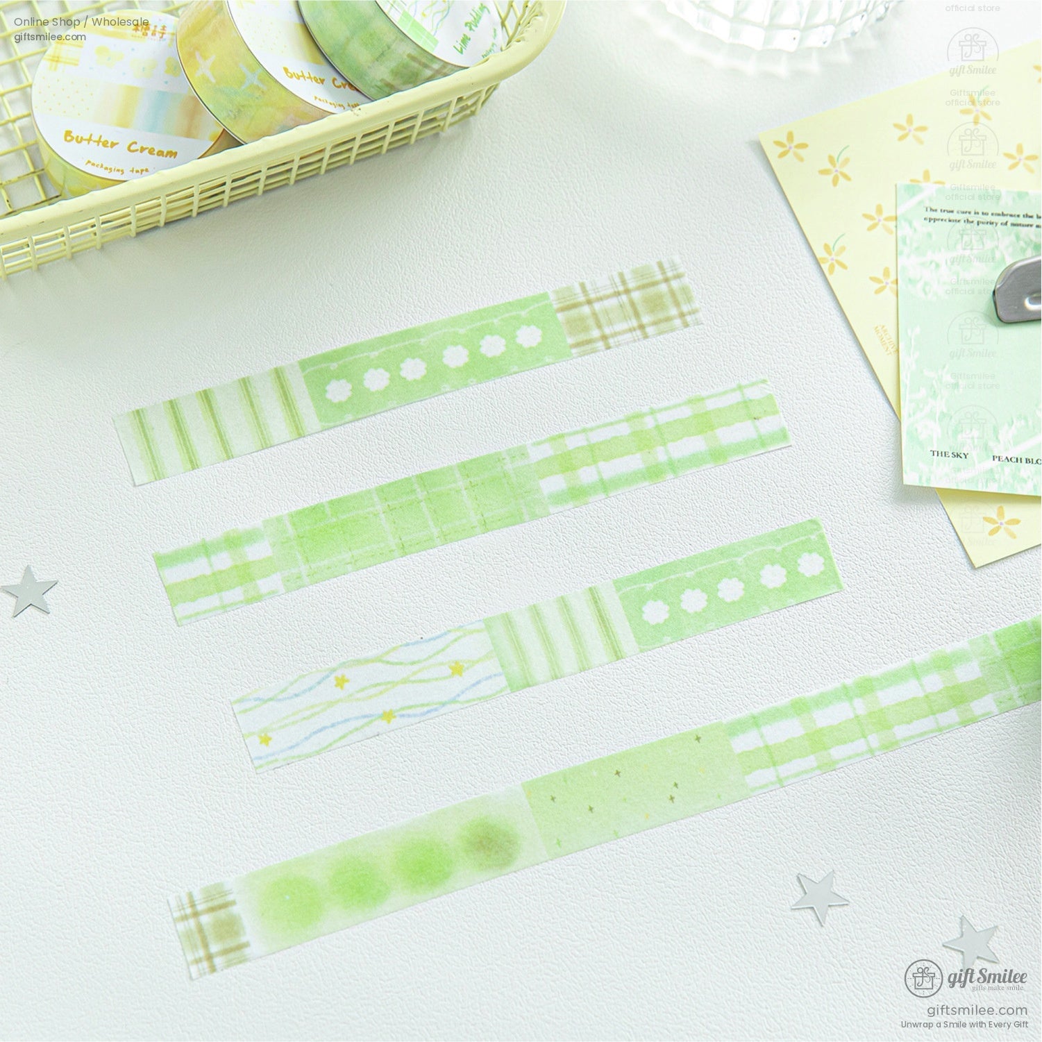 Green and yellow pastel washi tape set with floral and checkered patterns laid out on a white surface
