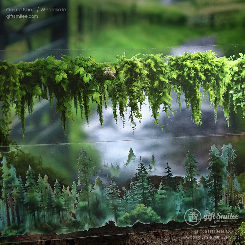 A close-up of a forest-themed washi tape roll with lush green foliage and scenic trees