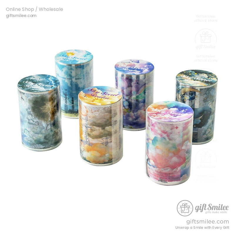 Six rolls of washi tape with cloud, rainbow, and galaxy patterns arranged neatly against a white backdrop