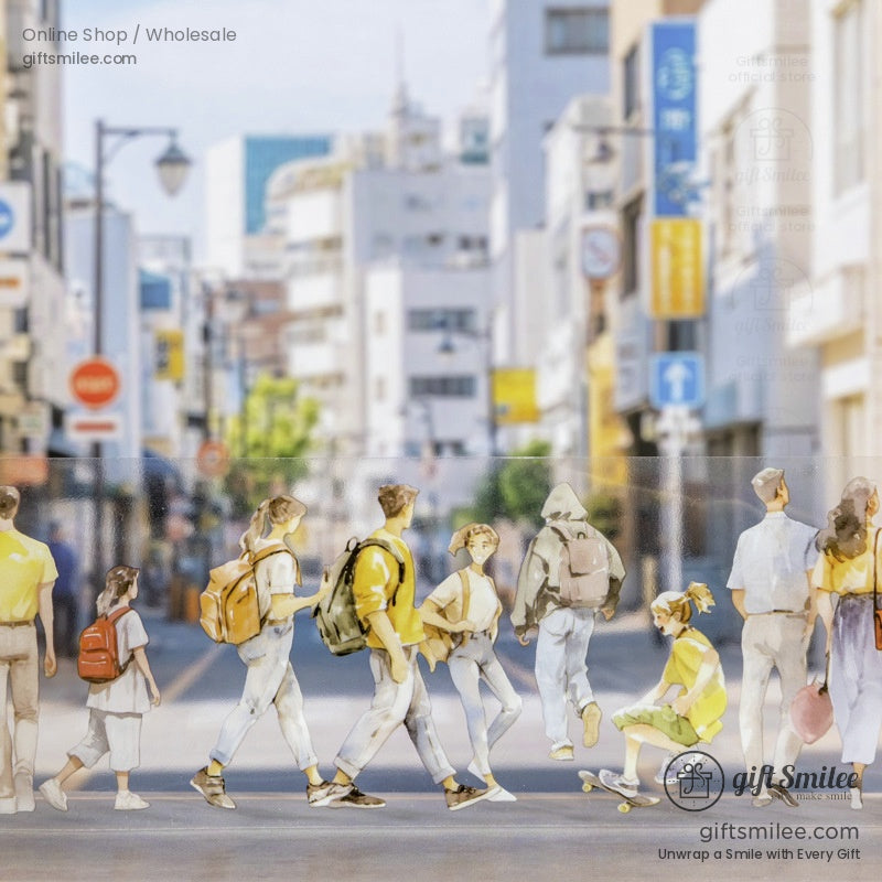 A scene of people crossing a busy city street on a roll of watercolor washi tape
