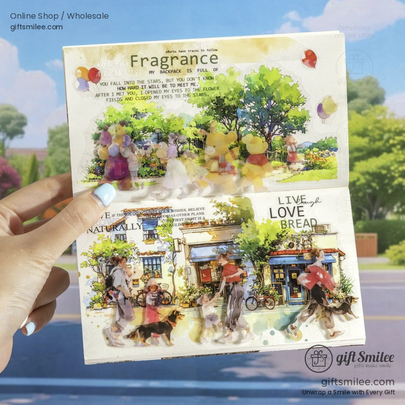 An open scrapbook page featuring watercolor washi tape designs of children, balloons, and a bakery storefront