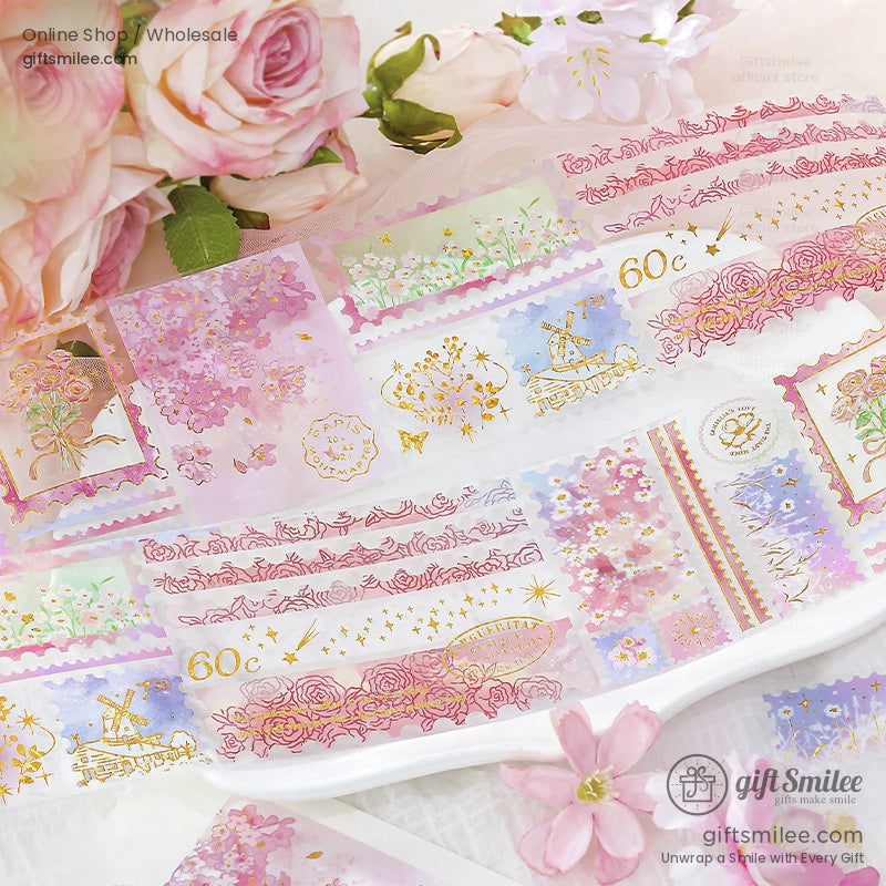 Close-up of pink floral stamp design washi tape surrounded by roses and petals, highlighting intricate details
