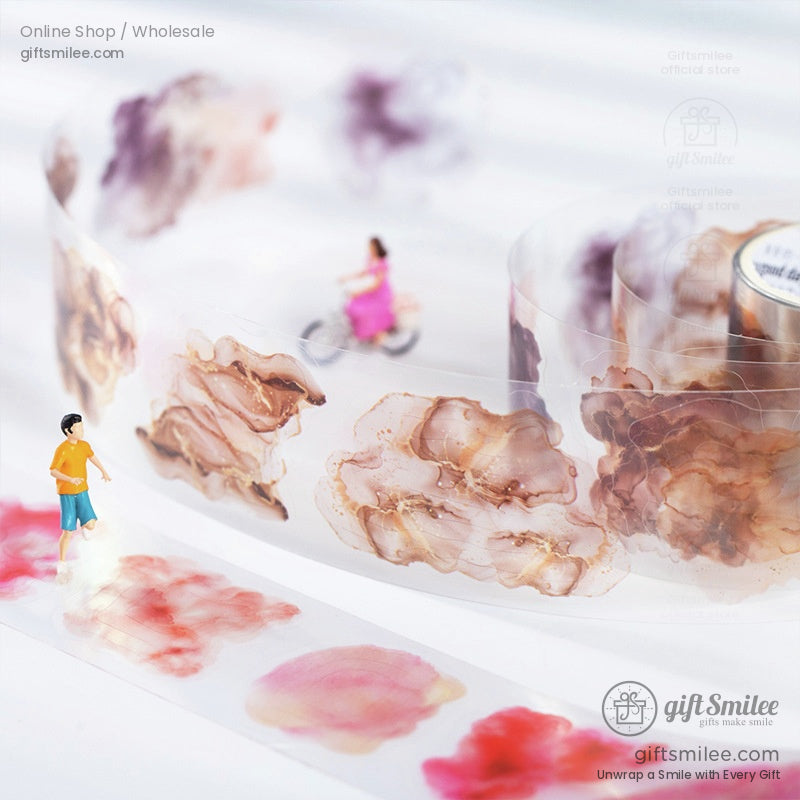 Miniature figures surrounded by artistic watercolor washi tape designs