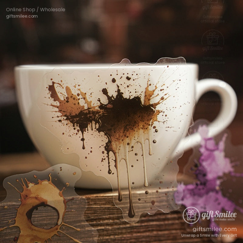 White coffee cup with coffee splash-themed stickers and a blurred coffeehouse background.