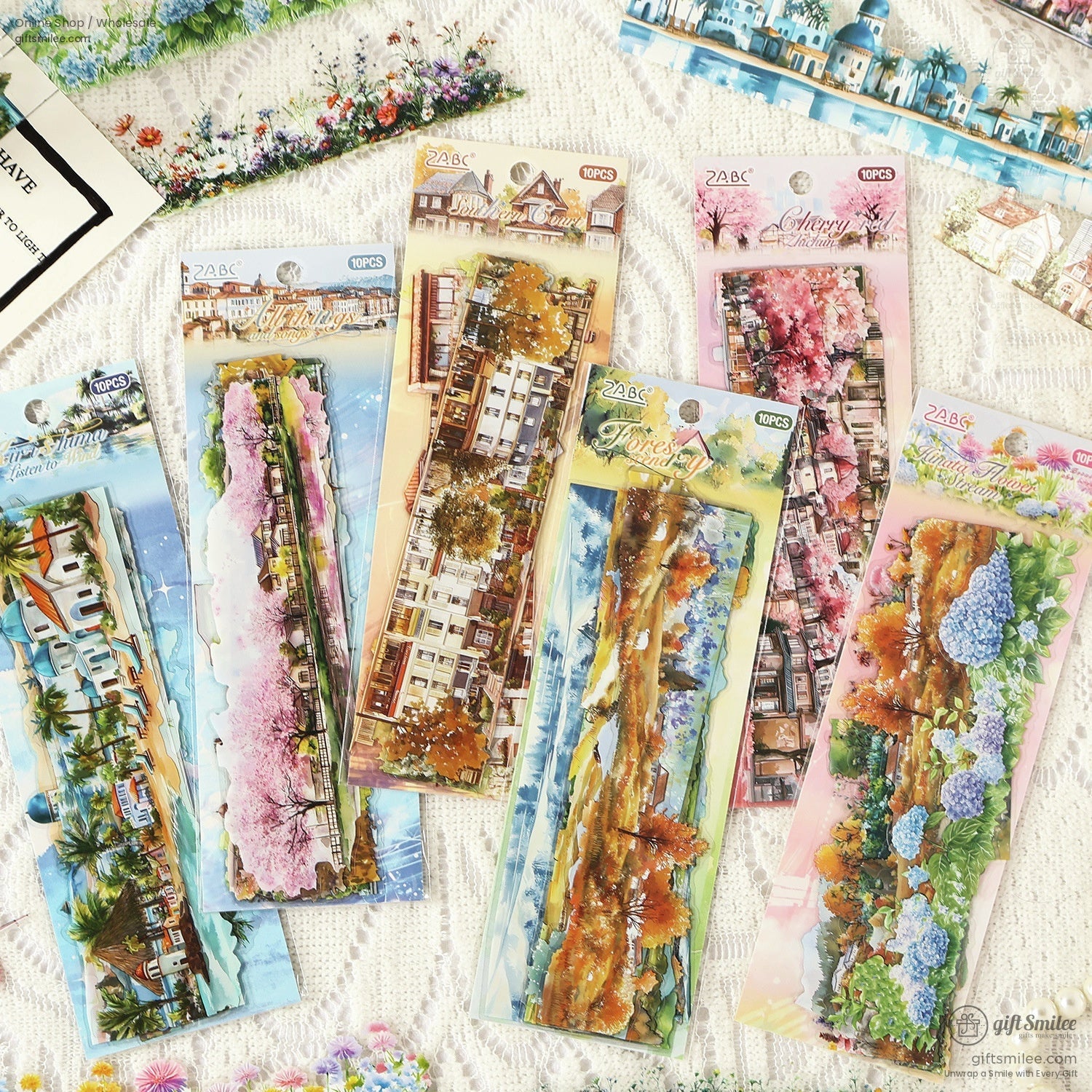 Close-up of six packs of scenic washi stickers featuring landscapes, cherry blossoms, and natural scenery