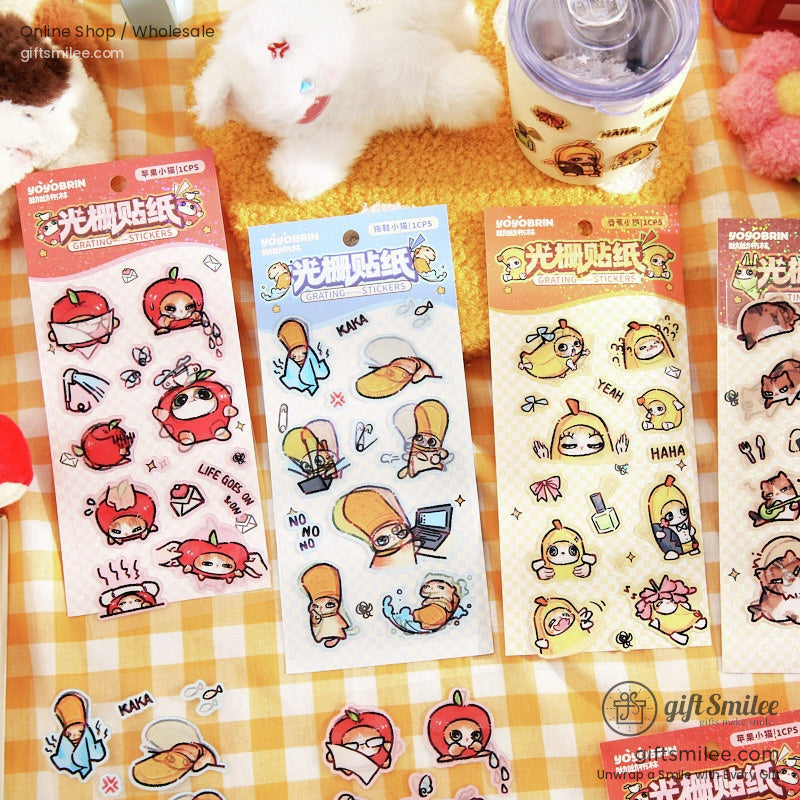 Variety of kawaii stickers featuring apples, bananas, and cats on a checkered background