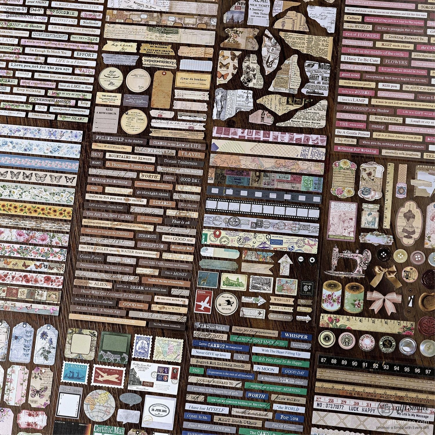 Close-up of retro scrapbooking stickers and ephemera paper strips on a wooden surface
