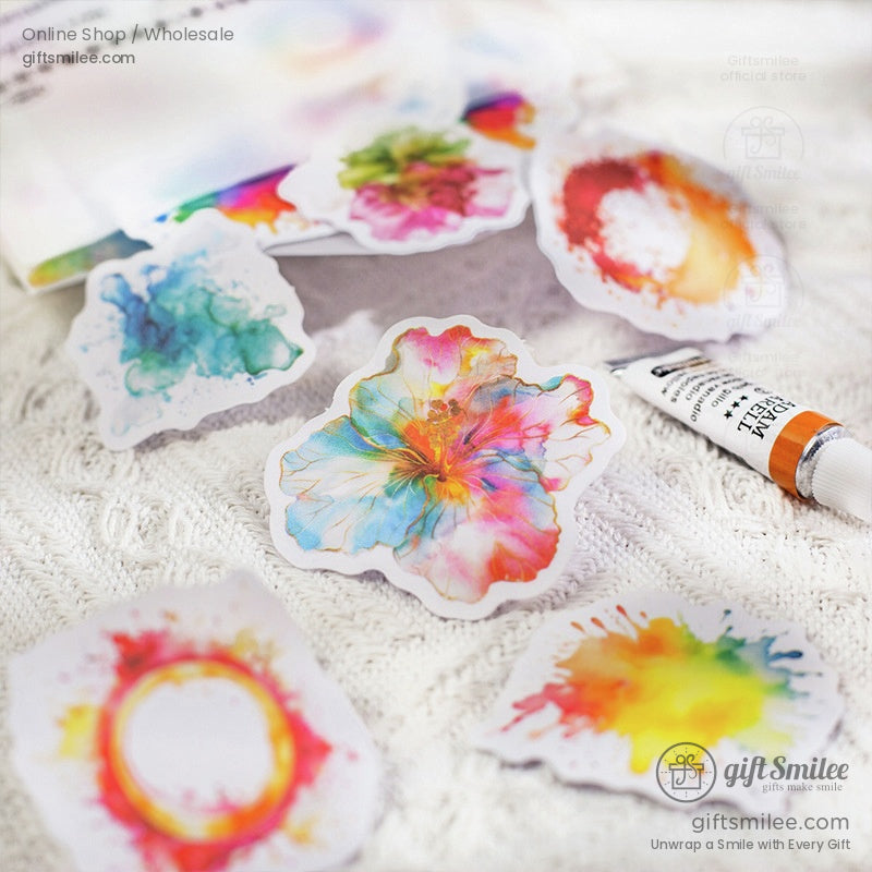 Close-up of watercolor floral and splash stickers with a soft artistic background