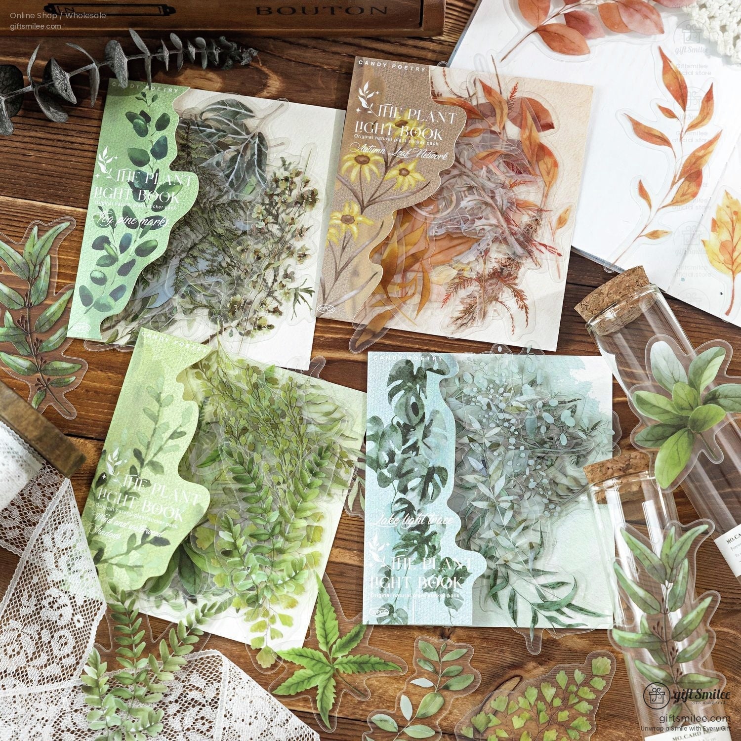 Rustic botanical sticker collection featuring various green leafy designs on a wooden table