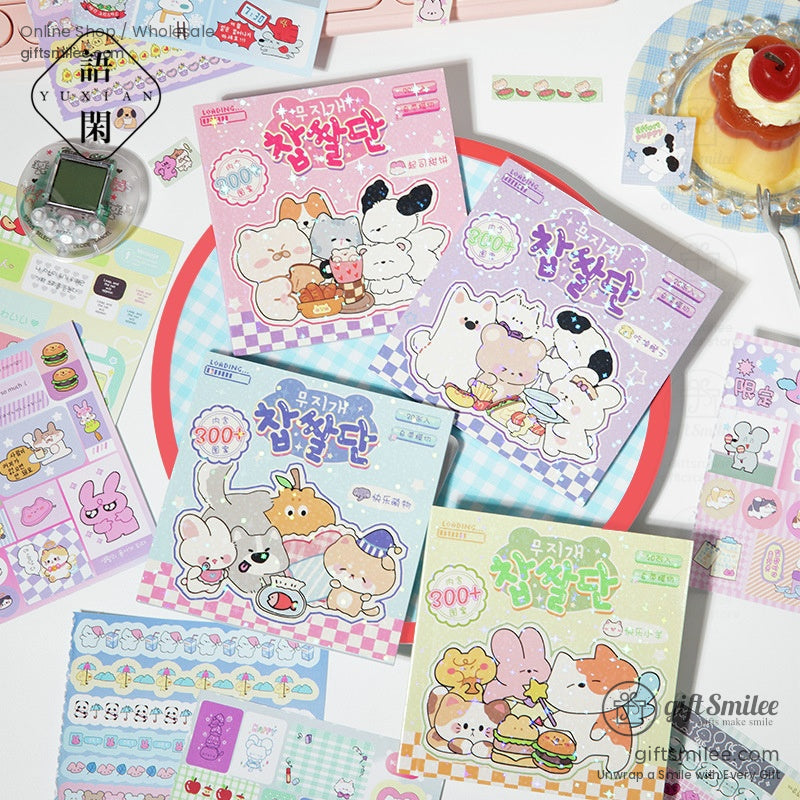 Four packs of Korean-style sticker sets displayed on a table surrounded by journaling supplies