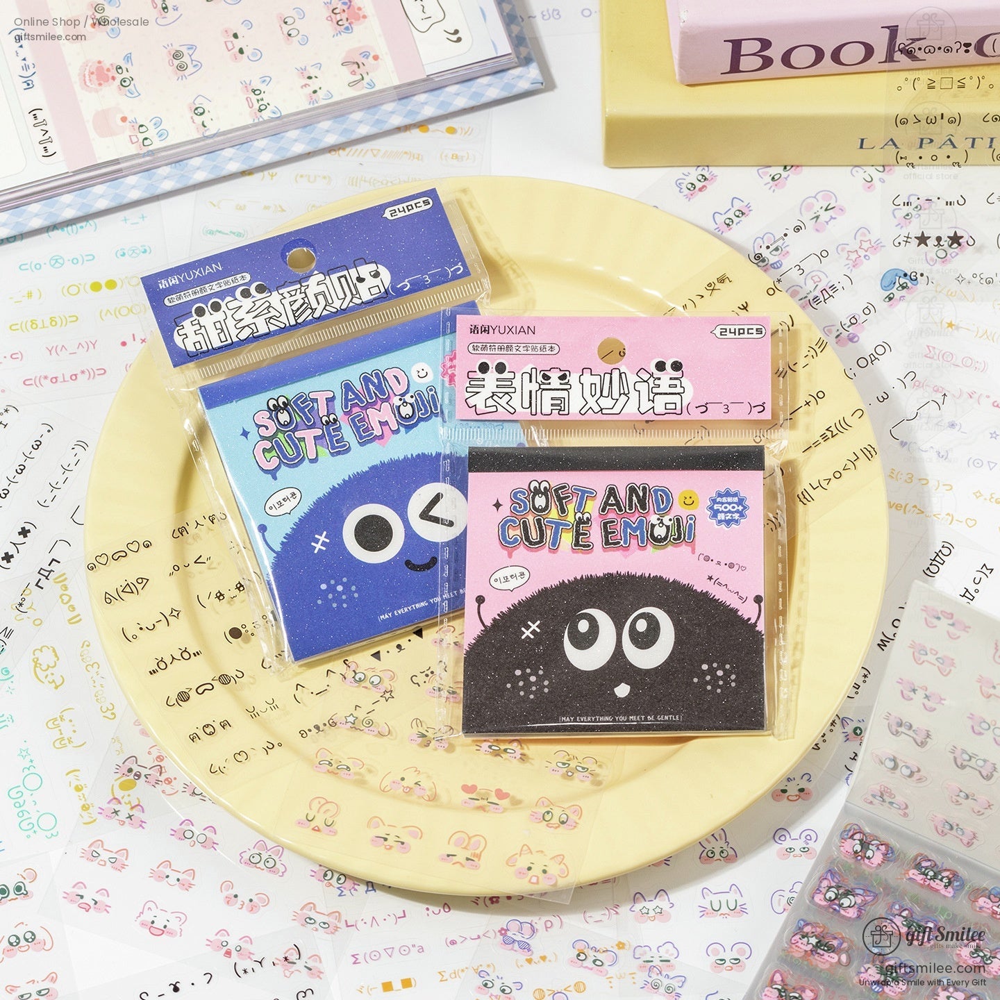 Kawaii emoji sticker packs displayed on a yellow plate with colorful packaging