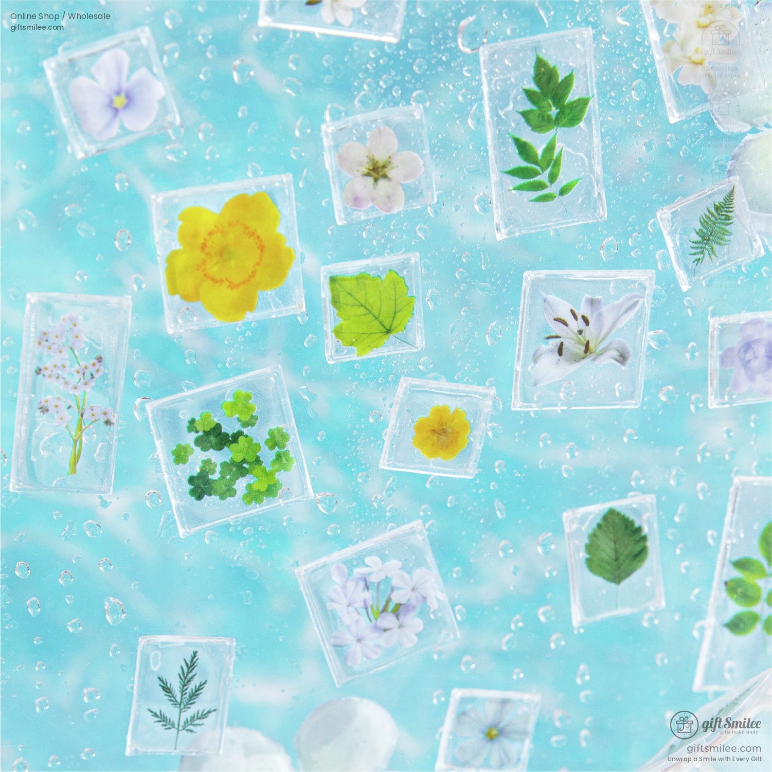 Close-up view of colorful flower and leaf stickers floating on a water-like blue background