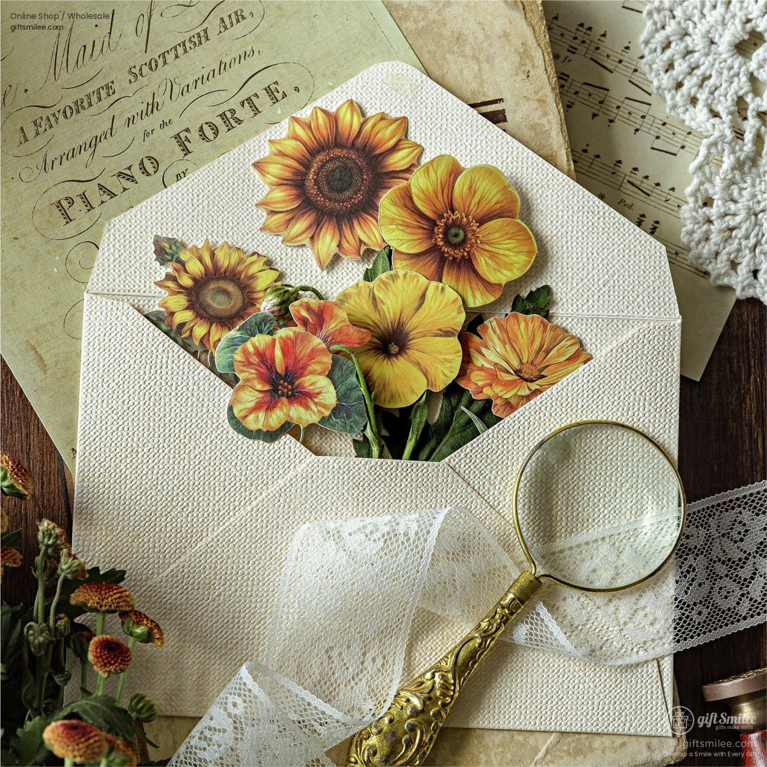 Vibrant sunflower and marigold stickers inside an envelope with vintage decor