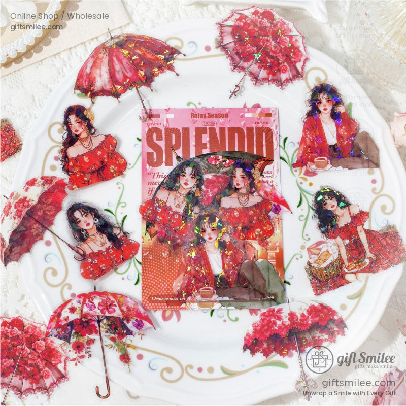 Close-up of red-themed Victorian girl stickers and floral umbrellas displayed elegantly