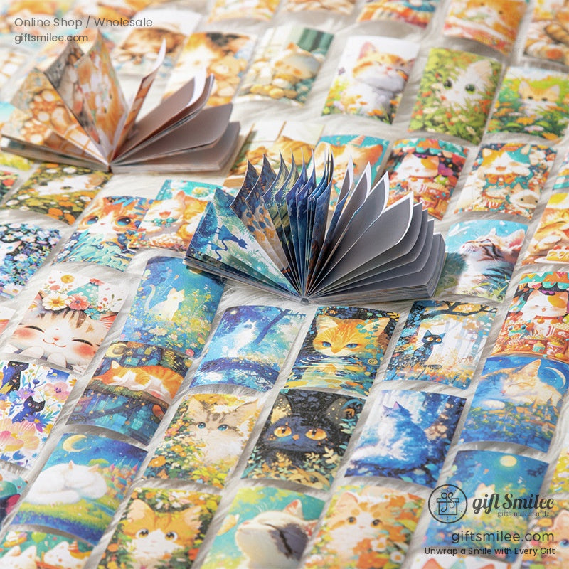 Spread-out collection of illustrated cat mini notebooks with colorful designs and open pages