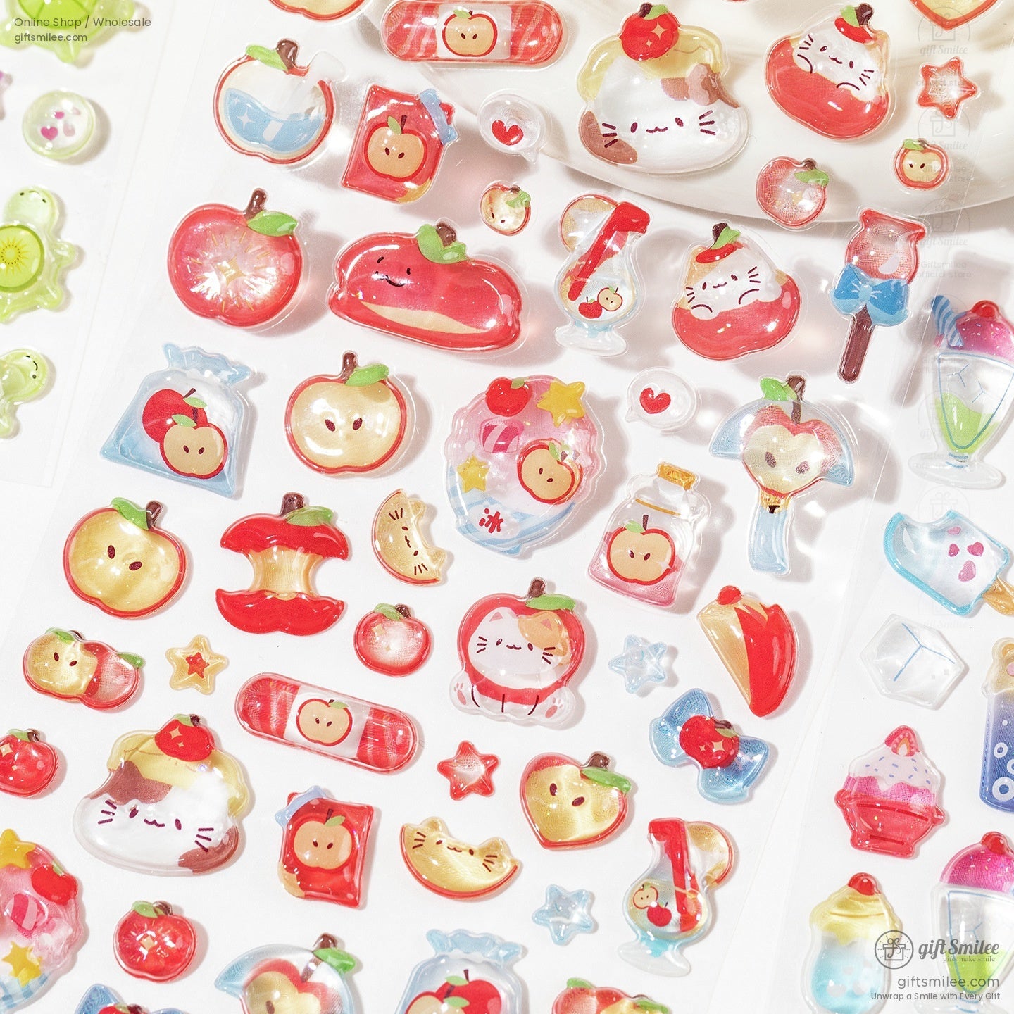 Close-up of apple-themed 3D stickers, including adorable cats and various apple designs