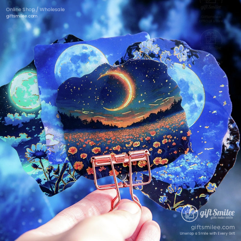 Close-up of moon and flower-themed stickers with vibrant blue and orange colors, perfect for journaling