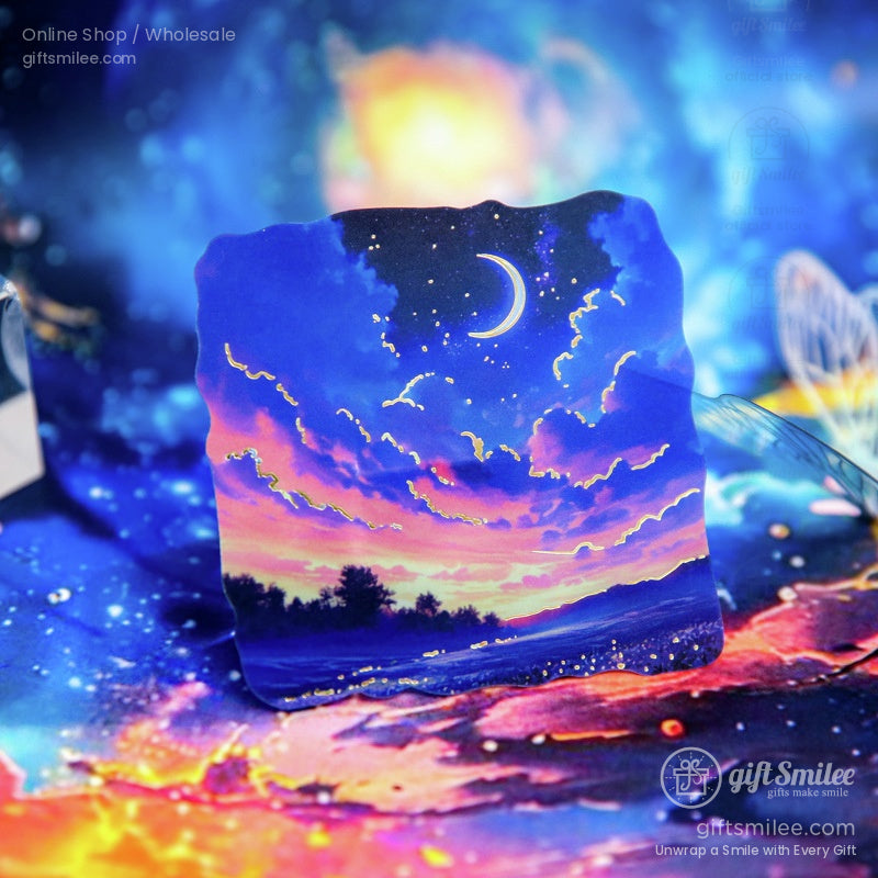 A dreamy sticker depicting a crescent moon and a vibrant sunset sky with stars, ideal for scrapbooking