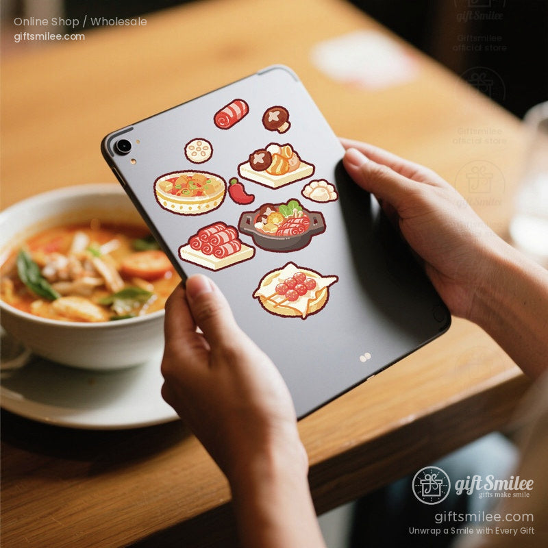 Kawaii food stickers displayed on a tablet with a bowl of ramen in the background