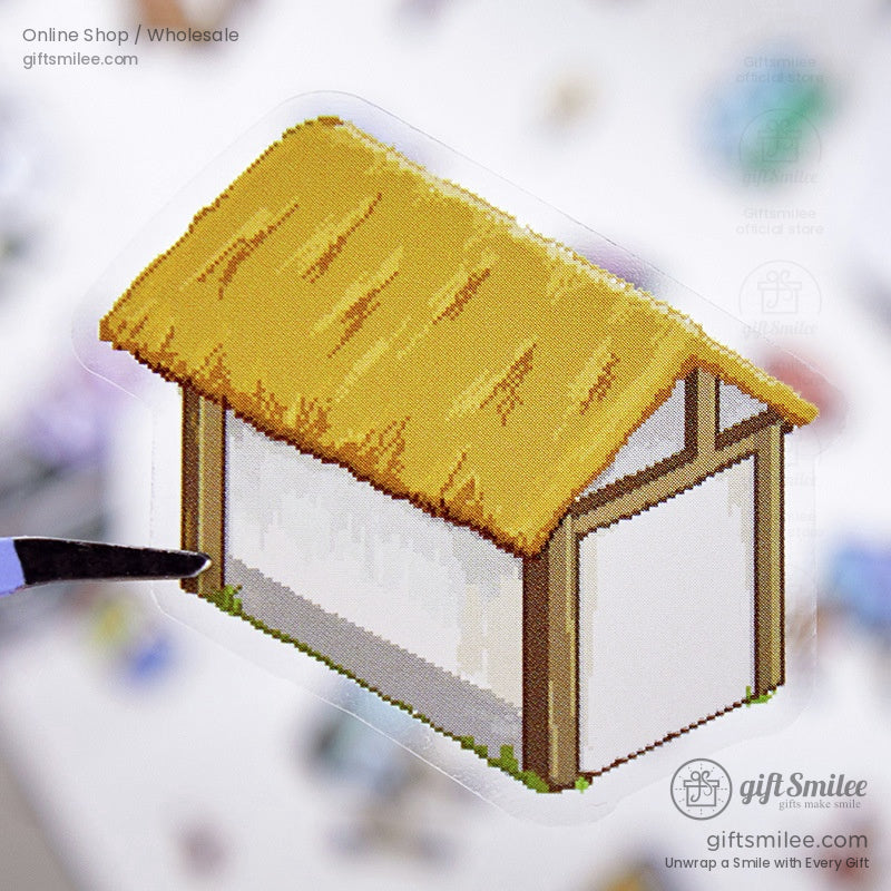 A detailed close-up of a tiny thatched house sticker, perfect for crafting