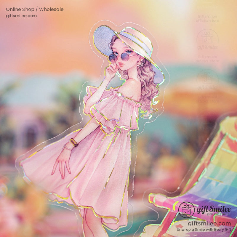 A chic girl in a pink dress with a sun hat and sunglasses, posing near a colorful beach chair