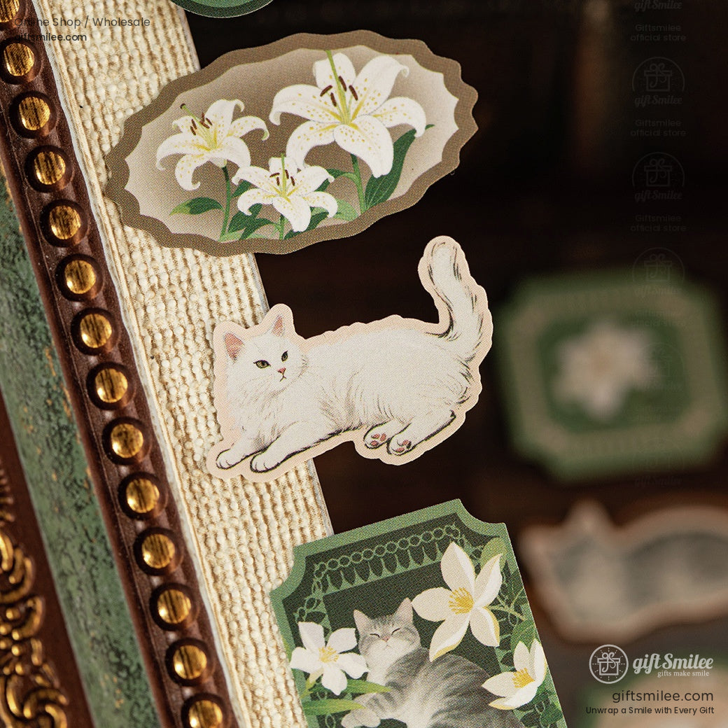 Elegant white cat and floral stickers displayed on a textured surface, showcasing their vintage charm