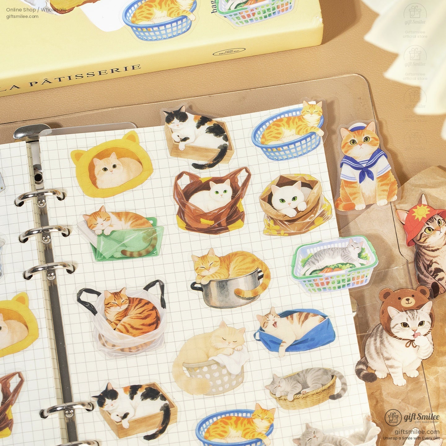 Cat-themed stickers displayed in a journal, featuring playful and cozy cats