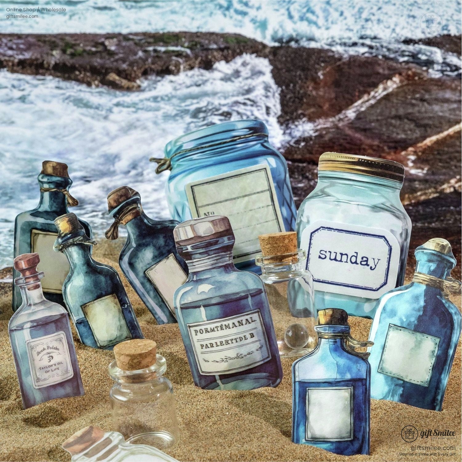 Blue and clear bottle stickers placed on a sandy beach by the ocean
