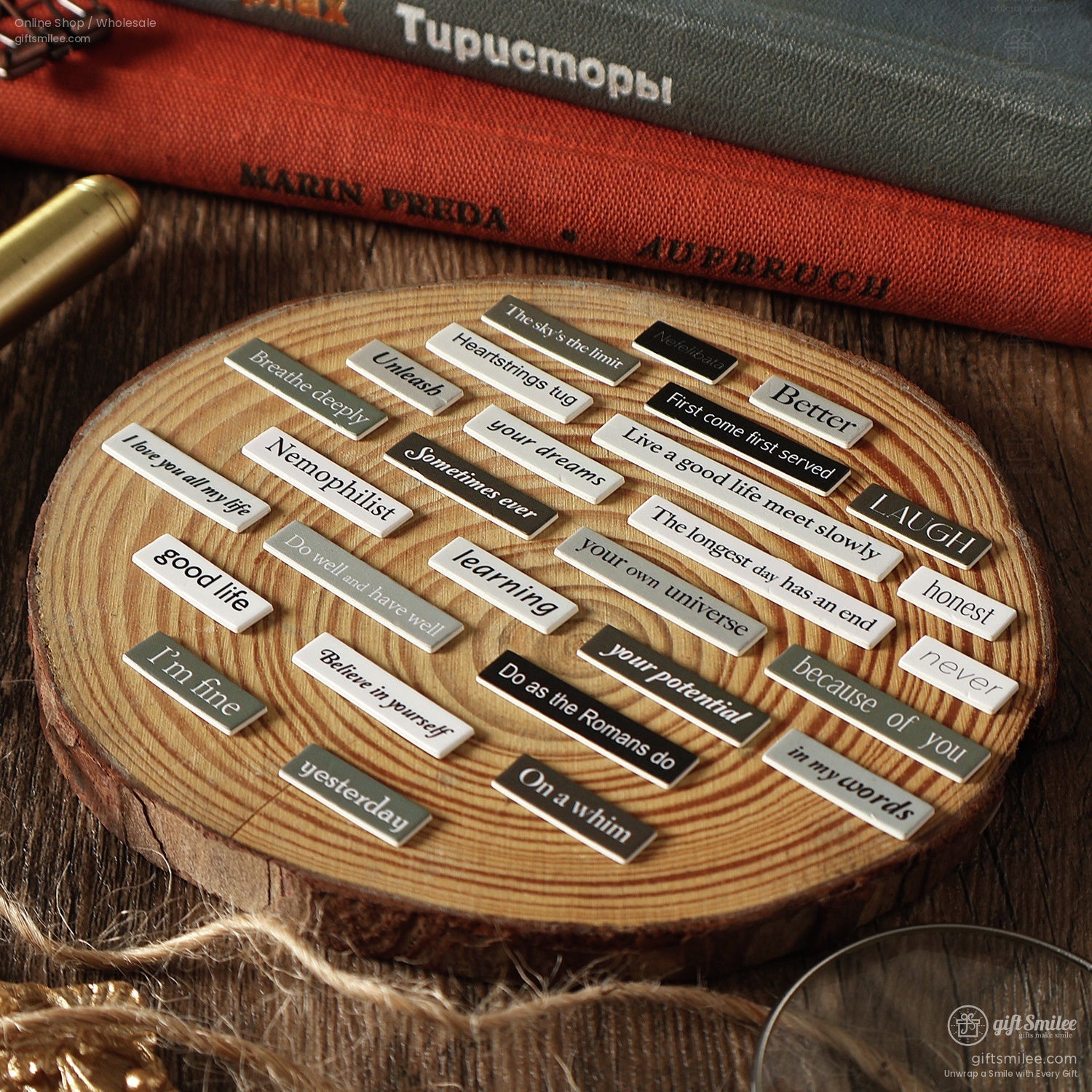 Inspirational text stickers arranged on a wooden coaster for DIY crafting
