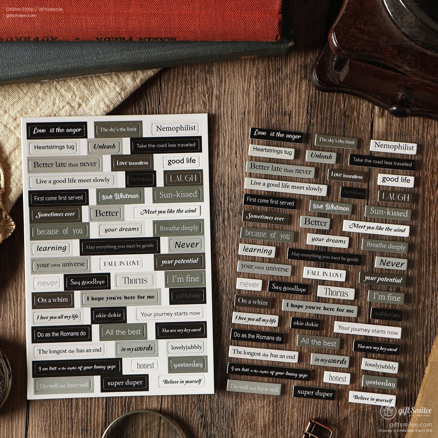 Retro-themed scrapbooking text stickers displayed on a textured wooden table