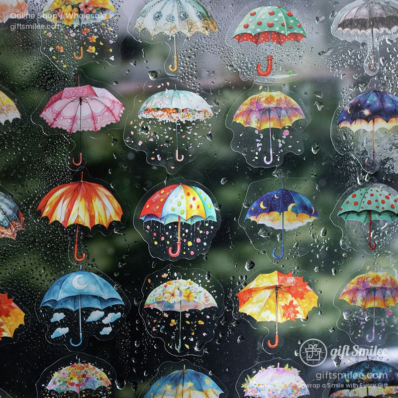 Assorted umbrella-inspired stickers with vibrant designs against a rainy glass background