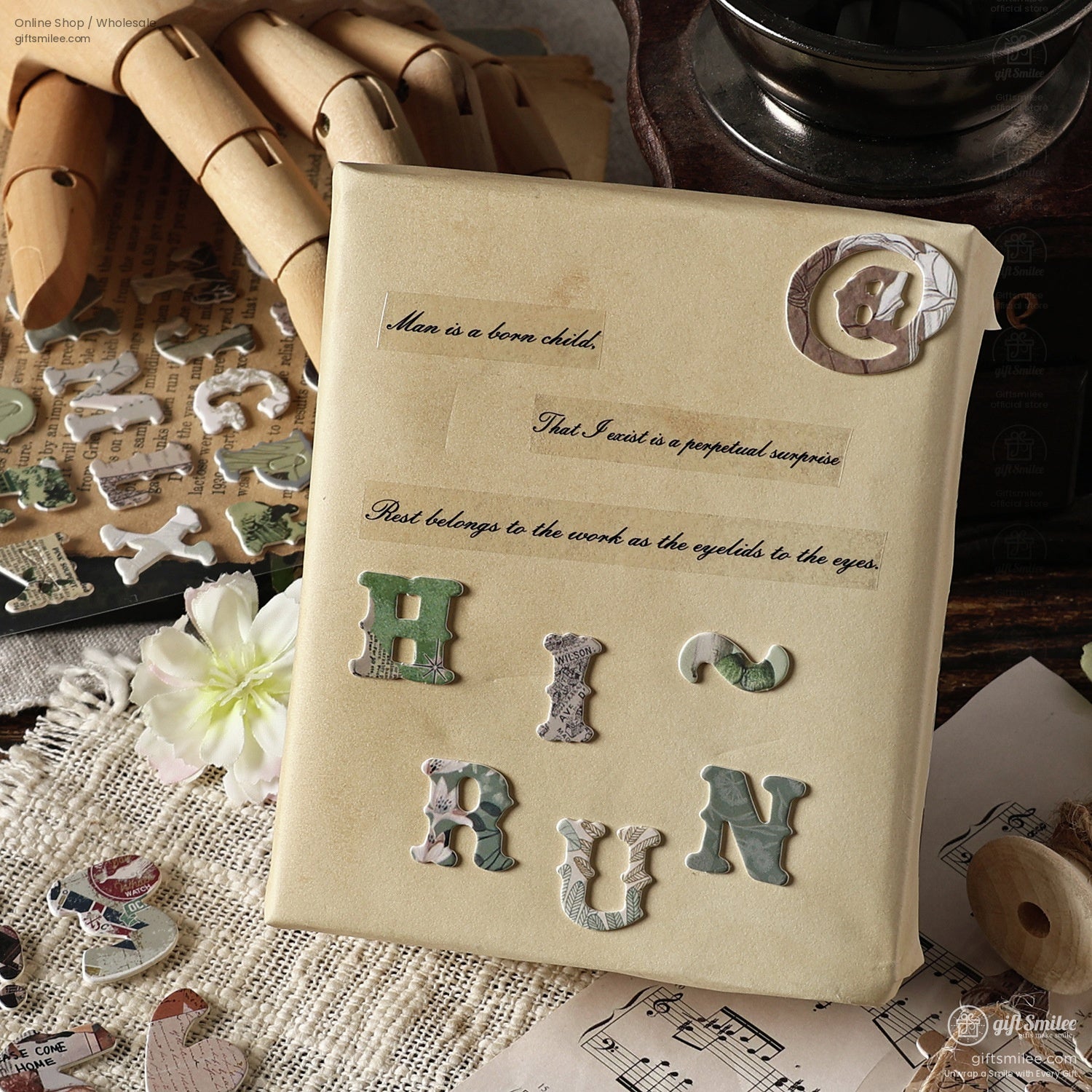 A retro-themed setup showcasing alphabet stickers spelling HI RUN on aged paper surrounded by crafting tools and flowers