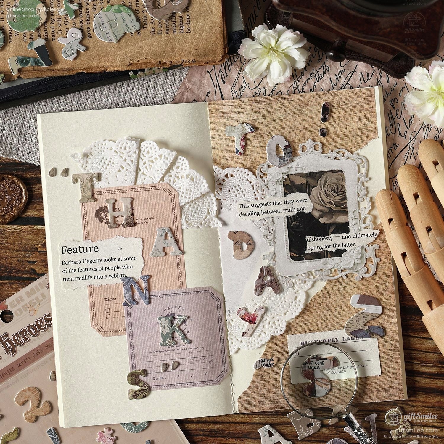 A creative journal spread decorated with vintage alphabet stickers, lace cutouts, and retro embellishments