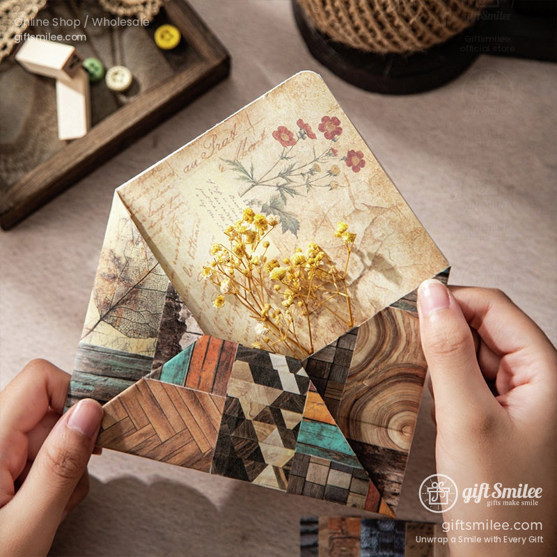 A handmade envelope crafted with rustic scrapbook paper, holding dried flowers