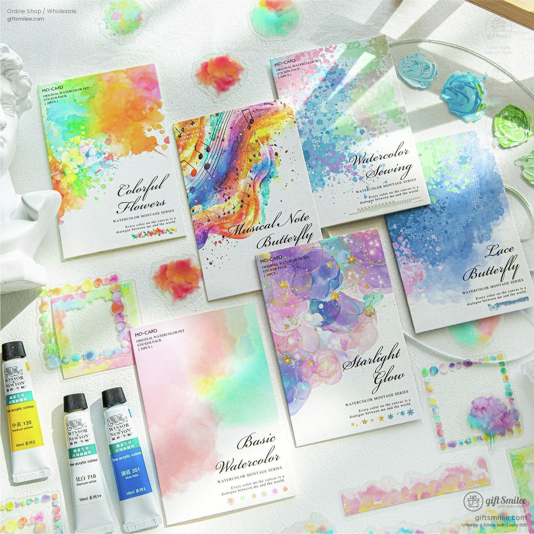 Colorful watercolor sticker set featuring floral and abstract designs on a light art studio background