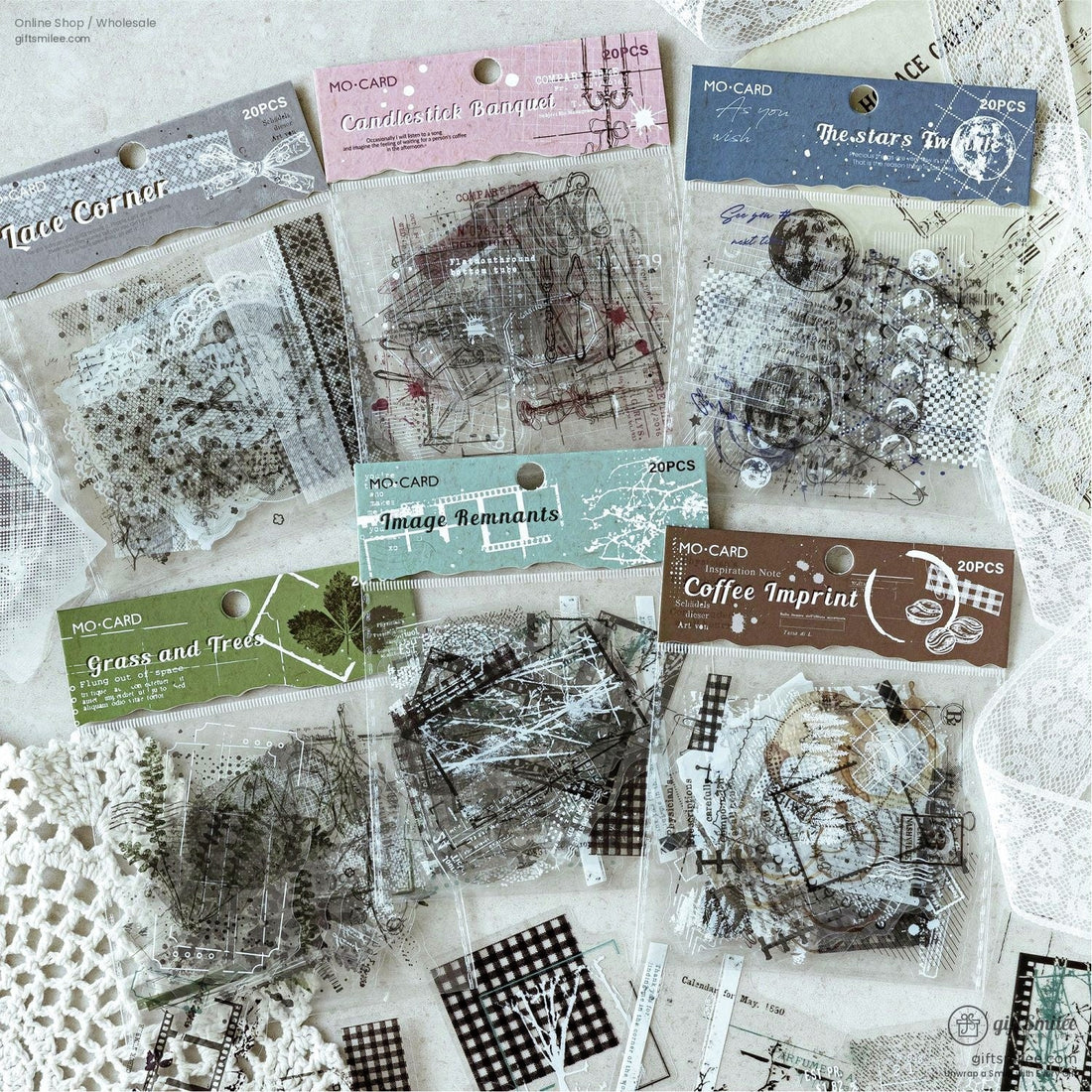 A flat lay of transparent celestial-themed stickers featuring stars, moons, and vintage text designs, perfect for scrapbooking or journaling