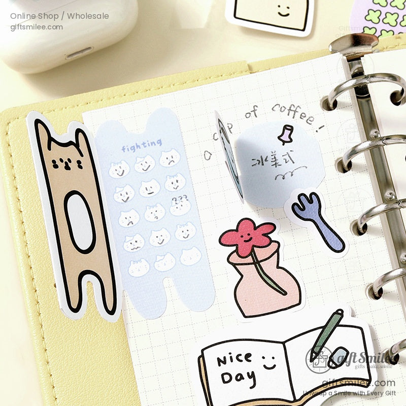 Stickers in a planner showing designs like cats, flowers, and coffee mugs for creative journaling ideas