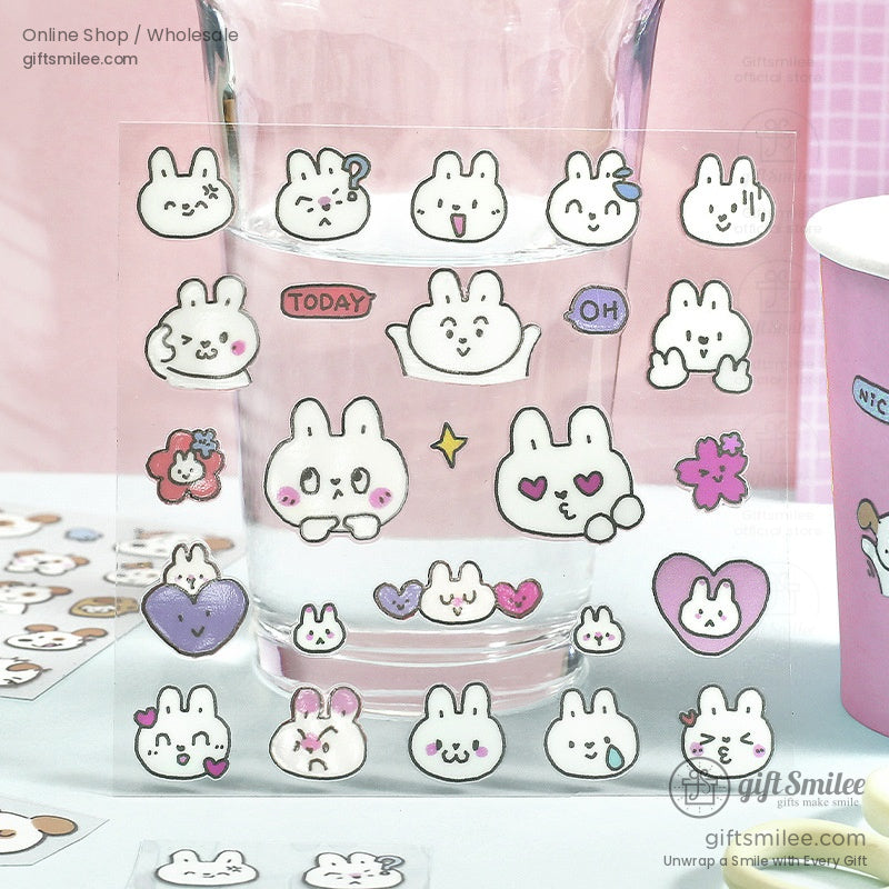 Transparent bunny stickers displayed on a glass surface with cute details