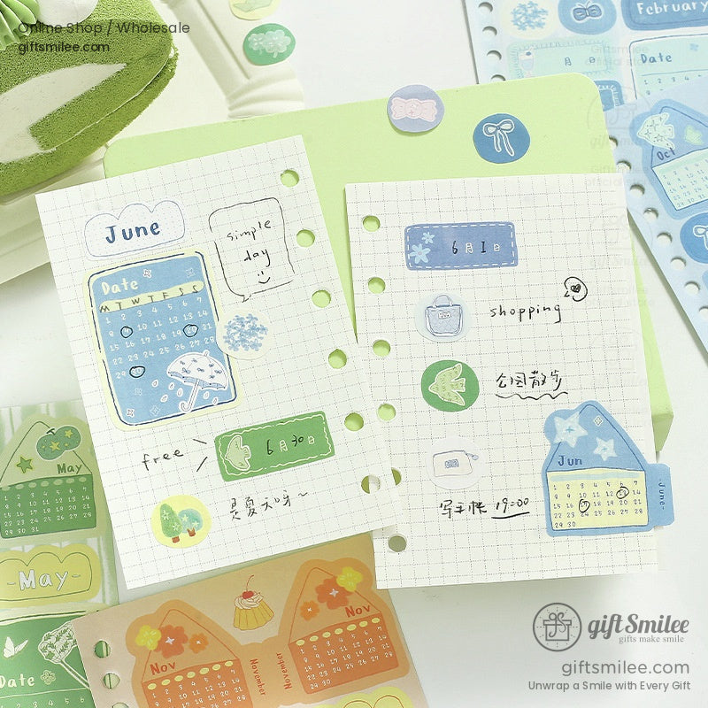 June and May pastel calendar stickers on a green grid notepad with a minimalist aesthetic
