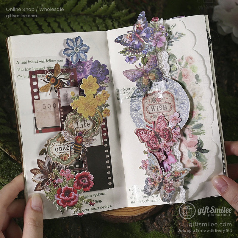 Embroidery stickers arranged in a journal with floral designs, butterflies, and intricate details for scrapbooking