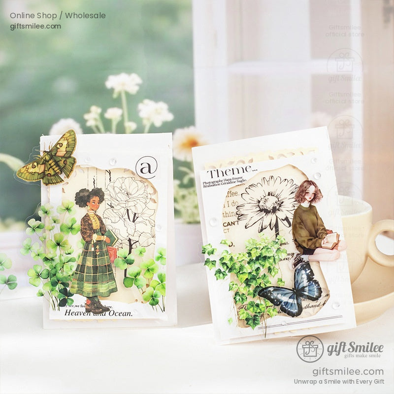 Journaling cards decorated with vintage nature stickers, butterflies, and floral elements on a sunny table
