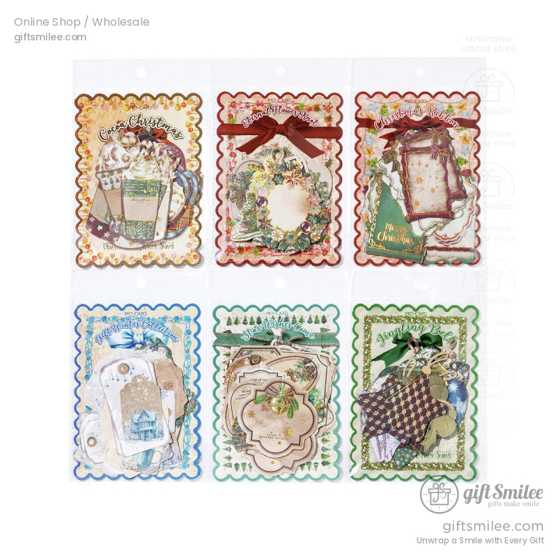 Packaged Christmas ephemera sets with scalloped edges and festive designs for crafting and journaling